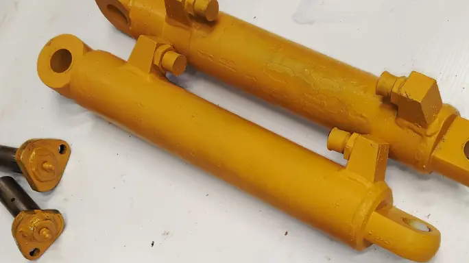 Hydraulic cylinder parts showing machining and component restoration work